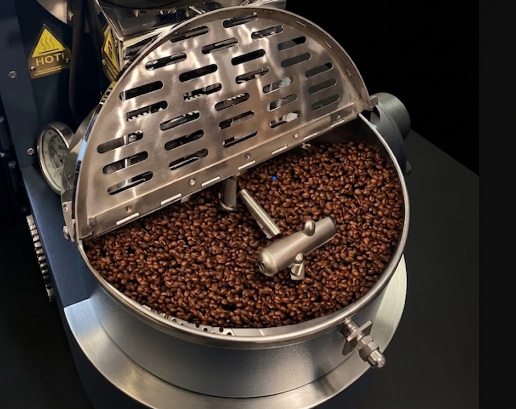Freshly roasted coffee beans in the roaster drum, ready to be released after roasting